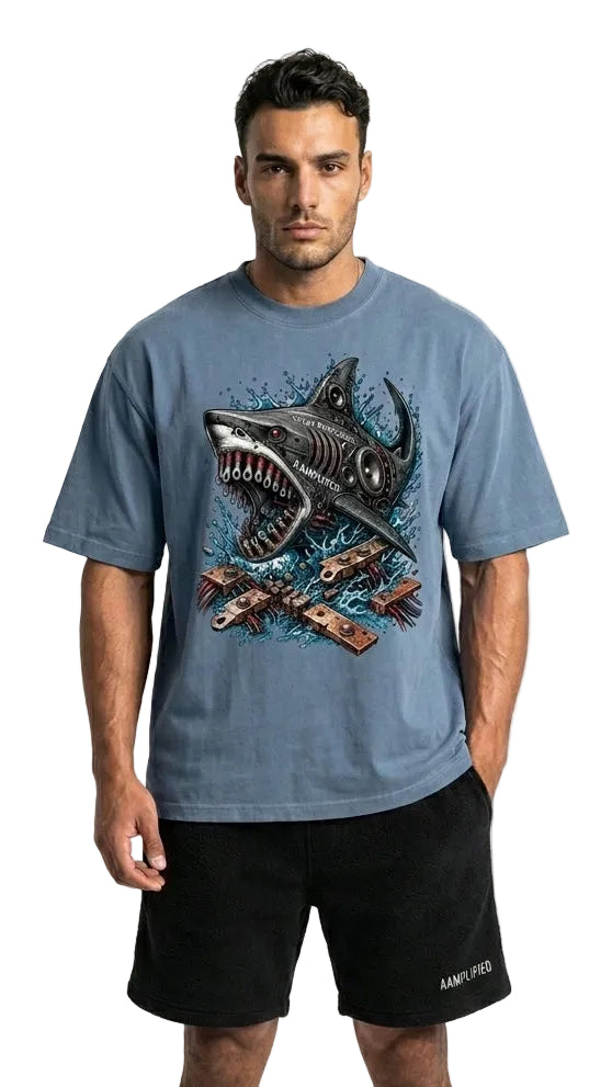Man wearing a blue t-shirt with a shark graphic and black shorts on a white background
