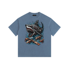 Blue t-shirt with a shark graphic design on a white background