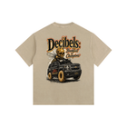 Beige t-shirt with a graphic of a car and 'Decibels' text on a white background