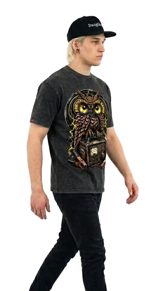 Person wearing a dark t-shirt with an owl design and black cap on a white background