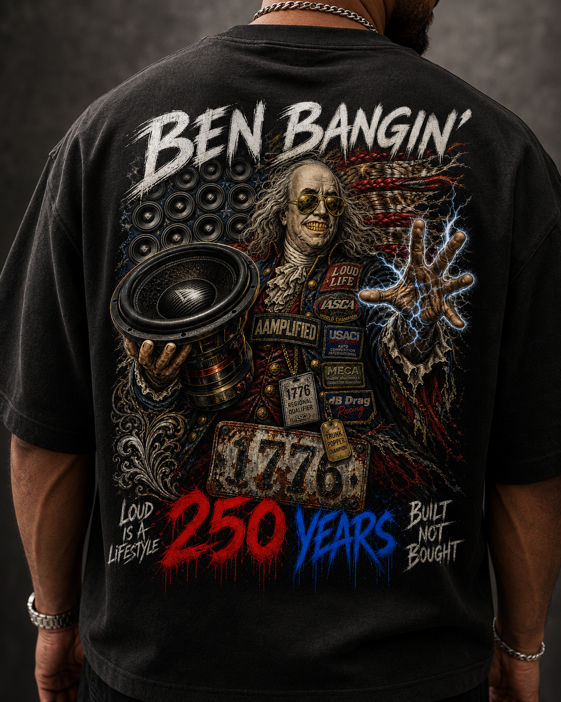 Black t-shirt with graphic design featuring a person holding a loudspeaker and text on the back.