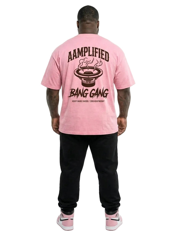 Person wearing a pink t-shirt with 'Bang Gang' design on the back, standing against a white background