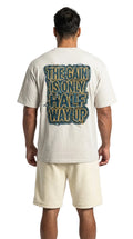 Person wearing a t-shirt with text on the back, standing against a white background