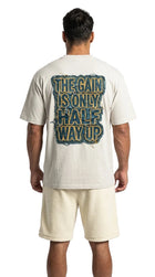 Person wearing a t-shirt with text on the back, standing against a white background