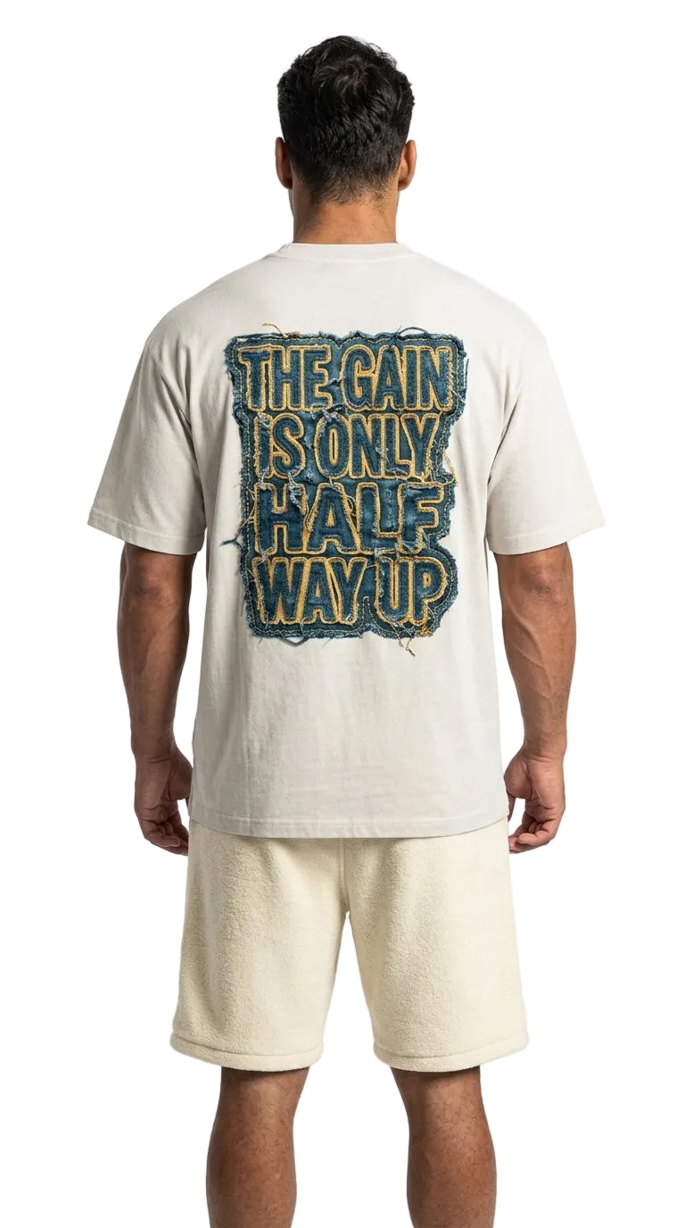Person wearing a t-shirt with text on the back, standing against a white background