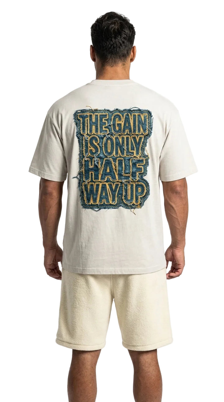 Person wearing a t-shirt with text on the back, standing against a white background
