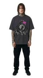 Person wearing a dark gray t-shirt with a graphic design on a white background