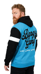 Man wearing a blue and black hoodie with 'Bang Gang' text on the back against a white background