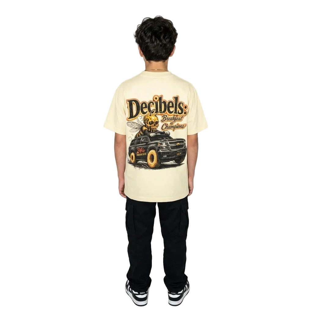 Person wearing a beige t-shirt with a graphic design on the back, standing against a white background