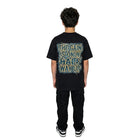 Person wearing a black t-shirt with text on the back against a white background