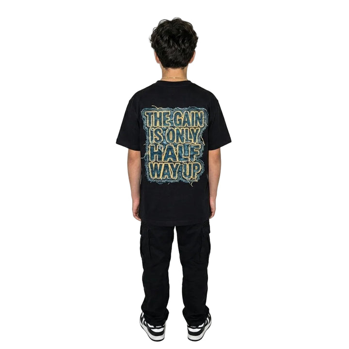 Person wearing a black t-shirt with text on the back against a white background