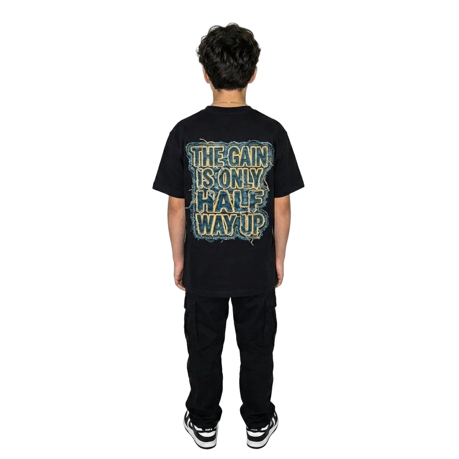 Person wearing a black t-shirt with text on the back against a white background