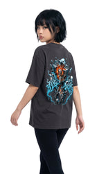 Person wearing a dark gray t-shirt with a colorful graphic design on the back, standing against a white background.