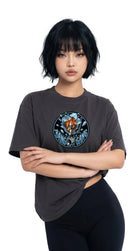 Person wearing a dark gray t-shirt with a graphic design on a white background